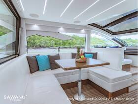 The interior of the Lady M Sunseek 2020 54 FT motor yacht features a stylish lounge area with comfortable seating and a table adorned with fresh fruit, perfect for relaxing on the water.