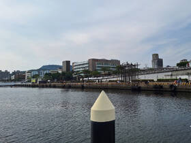 A view of a waterfront area with buildings and people along the shore, but the image lacks clarity and focus.