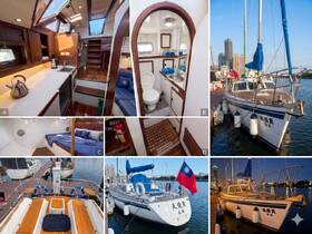 A detailed view of the interior of a sailboat, showcasing the cabin, helm, and bathroom facilities — perfect for comfortable cruising and overnight trips.