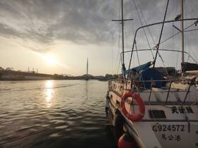 A serene sunset view with people aboard a boat, creating a picturesque scene perfect for evening cruises.