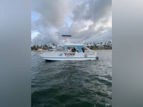 A side view of the 'Titan' boat party vessel docked in calm waters, showcasing its inviting design and perfect for group celebrations.