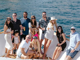 A lively group of friends enjoys a day on a yacht, celebrating with cocktails and laughter — the perfect backdrop for unforgettable memories on the water.