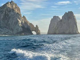 A stunning view of the iconic rock formations at Cabo San Lucas, showcasing the natural beauty of the coastline — perfect for sightseeing and photography.