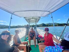 A lively group enjoys a boat ride, capturing moments of fun and camaraderie on the water — perfect for group outings and adventures.