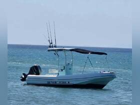 A sleek speedboat named 'Fish On' is anchored in calm waters, showcasing its fishing gear and inviting design — perfect for a day out on the ocean.