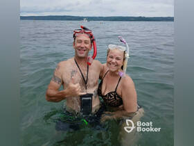 A happy couple enjoys snorkeling in clear waters, showcasing the joy of underwater adventures and memorable experiences on the water.