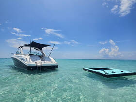 A sleek boat anchored in crystal-clear waters, showcasing a perfect day for relaxation and exploration on the water.