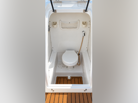 Interior view of a boat bathroom featuring a clean toilet and practical storage, ideal for comfort on long journeys.