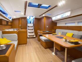 A beautifully designed interior of a sailboat featuring cozy seating and a well-equipped cabin, perfect for relaxing during your nautical adventures.