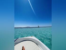 A serene view from a boat showcasing stunning turquoise waters and a distant island, perfect for capturing the essence of a relaxing day on the water.