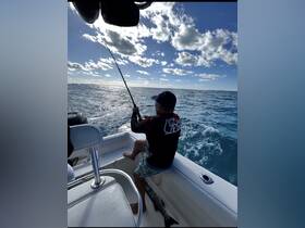 A fisherman enjoys a day on the water, casting his line while surrounded by the beautiful ocean scenery — a perfect moment for fishing enthusiasts.