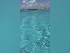 A view of clear turquoise waters, but the image lacks clarity and focus, making it difficult to identify specific features or subjects.