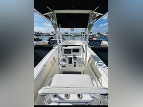Interior view of a boat's helm and seating area, showcasing the control console and comfortable seating, ideal for navigating the waters.