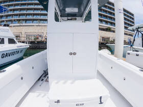 A clean and spacious helm area of a boat, featuring a YETI cooler and sleek console design, perfect for comfortable navigation and relaxation on the water.