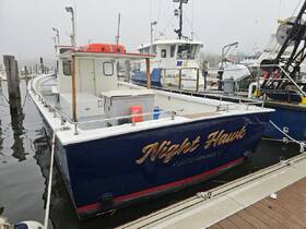 The 'Night Hawk' boat is docked at a marina, showcasing its structure against a foggy backdrop — perfect for fishing trips or leisure outings.