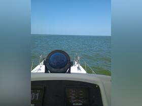 View from the helm of a boat, showcasing the dashboard and the open water ahead, perfect for navigating the seas.