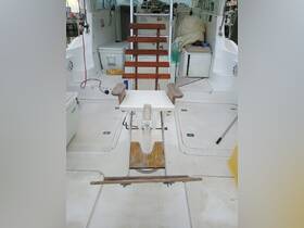 A detailed view of a fishing chair inside a boat's helm area, showcasing the functional design and layout for comfortable fishing experiences.