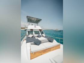 A stylish lounge area on the deck of a yacht, featuring comfortable cushions and a sleek design, perfect for relaxing while enjoying the ocean views.