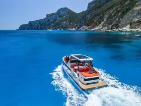 A vibrant scene of a boat cruising through crystal-clear waters, with stunning cliffs in the background — perfect for exploring beautiful coastlines.