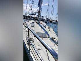 A clear view of a sailboat's deck at the dock, showcasing its structure and rigging against a backdrop of other vessels.