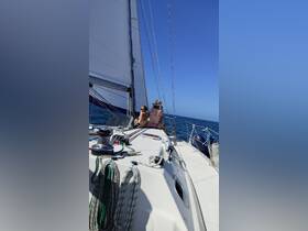 Two friends enjoy a sunny sailing experience on the open ocean, capturing the essence of relaxation and adventure on the water.