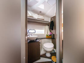 A well-designed boat bathroom featuring modern amenities, including a stylish sink and toilet, perfect for comfort while at sea.