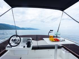 A beautifully arranged table on a boat featuring fresh fruit and drinks, perfect for a relaxing day on the water.