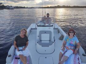 A group enjoys a relaxing moment on a boat, soaking in the sunset views — perfect for leisurely cruises and quality time on the water.