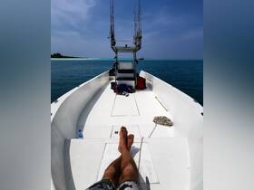 A relaxing moment aboard a fishing boat, showcasing the helm and seating area with fishing rods ready for action. Perfect for a day out on the water.