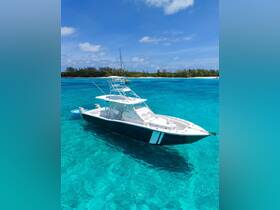 A stunning aerial view of a sleek speedboat cruising through crystal-clear turquoise waters, perfect for adventure seekers and day trips in tropical destinations.