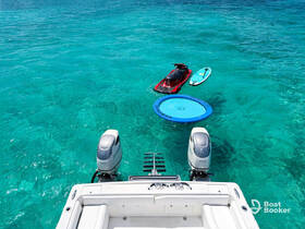 A vibrant scene showcasing a jet ski, paddleboard, and a floating mat in crystal-clear turquoise waters — perfect for a day of fun and relaxation on the water.