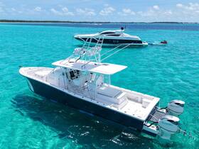 A stunning aerial view of a sleek speedboat cruising through crystal-clear turquoise waters, perfect for exploring the beautiful coastline.