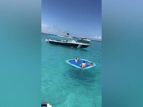 A group of friends enjoys a sunny day on a floating mat in crystal-clear turquoise waters, with boats anchored nearby — perfect for a fun day out on the water.