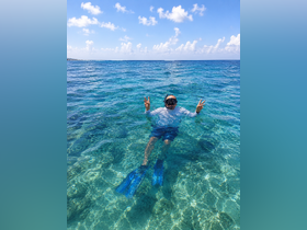 A snorkeler enjoys the vibrant underwater world in crystal-clear waters, showcasing the excitement of marine exploration.