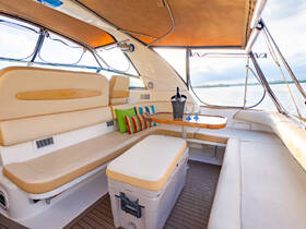 A beautifully designed interior of a Sea Ray boat, featuring comfortable seating and a cozy lounge area, perfect for relaxing while enjoying the views on the water.
