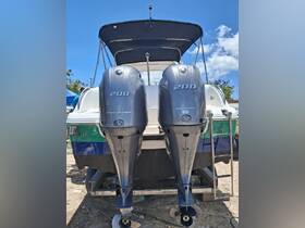 A clear view of the back of a boat featuring twin 200 HP outboard motors, showcasing its robust design and readiness for adventure on the water.