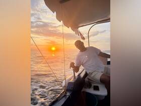 A person enjoys a serene sunset on a boat, capturing the tranquil beauty of the ocean — perfect for evening cruises and relaxation.