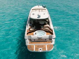 A stunning aerial view of a luxurious yacht cruising through crystal-clear turquoise waters, showcasing its elegant design and spacious deck.