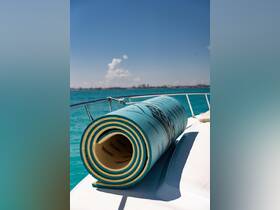 A vibrant floating mat rests on the deck of a boat, ready for fun in the sun on turquoise waters — perfect for relaxing or playing on the water.