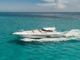 A stunning aerial view of a sleek yacht cruising through crystal-clear turquoise waters, perfect for luxury charters and island adventures.