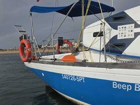 A close-up view of the side of a boat named 'Beep B' with life rings visible, docked in calm waters — perfect for a day of adventure on the sea.