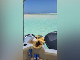 A vibrant display of fresh fruit and drinks on a boat, perfect for a relaxing day on the water. Enjoy the tropical flavors while soaking in the sun and stunning views.