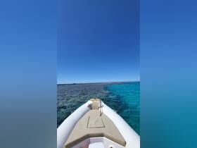 A clear view of a speedboat navigating through shallow turquoise waters, showcasing the vibrant coral reef below — perfect for exploring the beauty of marine life.