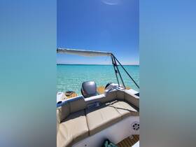A cozy seating area on a boat, featuring a clear view of the turquoise waters, perfect for relaxing while enjoying a day on the water.