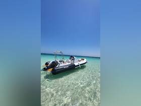 A sleek speedboat anchored in crystal-clear waters, perfect for exploring coastal destinations or enjoying a day on the water.