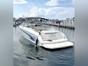 A sleek boat named 'Knot Scott' is docked at a marina, with a person at the helm, showcasing a perfect day on the water.