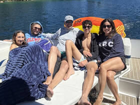 A group of friends enjoys a sunny day on a boat, relaxing and having fun together — perfect for summer outings and memorable adventures on the water.