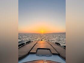 A stunning sunset view from the bow of a boat, showcasing the tranquil waters and the horizon — perfect for romantic evening cruises.