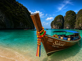 A stunning view of a traditional longtail boat named 'Sakae' docked on a pristine beach, surrounded by lush cliffs and crystal-clear waters, perfect for exploring tropical destinations.