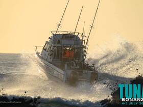 A dynamic shot of a speedboat cutting through the waves, showcasing its sleek design and power on the water — perfect for fishing adventures or thrilling outings.